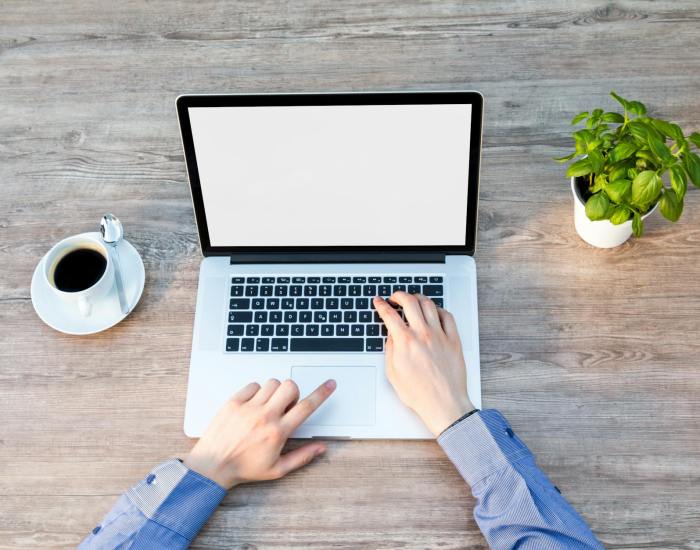 person s hand on laptop